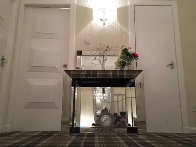 a clock in the middle of a room with two doors at Southfork Villa Guesthouse in Callander