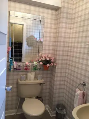a bathroom with a toilet and a mirror and a sink at Southfork Villa Guesthouse in Callander