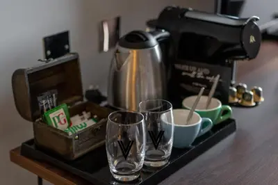 two glasses on a counter next to a coffee maker at Village Hotel Edinburgh in Edinburgh