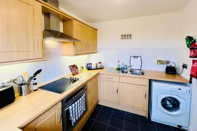 a kitchen with a sink and a washing machine at Beautiful & Spacious 2-Bed Flat in City Centre with Free Parking in Glasgow
