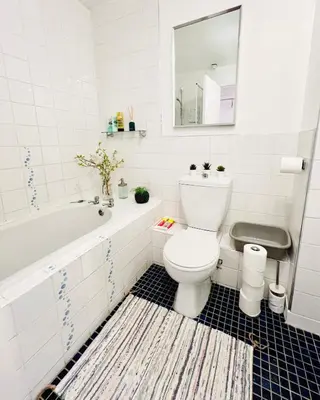 a bathroom with a toilet and a tub and a sink at Beautiful & Spacious 2-Bed Flat in City Centre with Free Parking in Glasgow