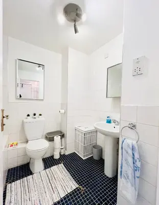 a white bathroom with a toilet and a sink at Beautiful & Spacious 2-Bed Flat in City Centre with Free Parking in Glasgow