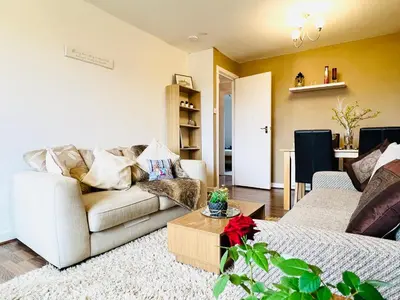 a living room with a couch and a table at Beautiful & Spacious 2-Bed Flat in City Centre with Free Parking in Glasgow