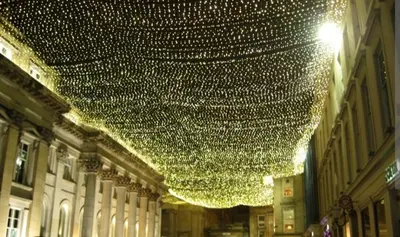 a bunch of lights hanging from a building at Spacious Modern Apartment in Glasgow