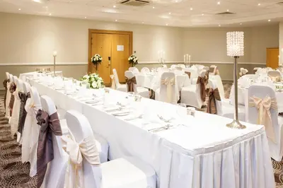 a large banquet room with white tables and chairs at Holiday Inn Glasgow - East Kilbride by IHG in East Kilbride