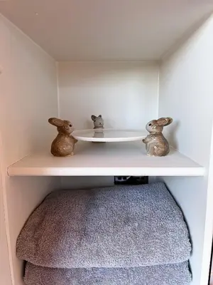 a shelf with two little figurines on top of it at Capledrae Farmstay Shepherds Huts in Cardenden