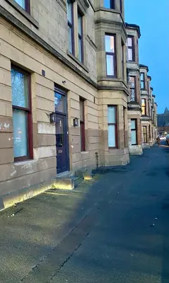 an empty street in front of a building at Boutique Home Stay - Bliss Studio in Paisley