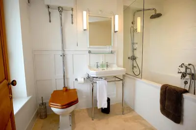 a bathroom with a toilet and a sink and a shower at The Lodge at Carrick Castle Estate in Cairndow