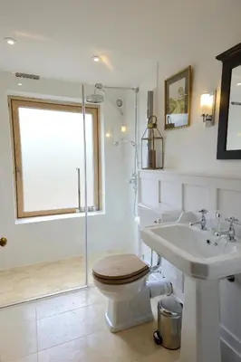 a bathroom with a toilet and a sink and a shower at The Lodge at Carrick Castle Estate in Cairndow