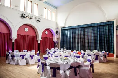a banquet hall with tables and chairs in a building at The Pipers' Tryst Hotel in Glasgow