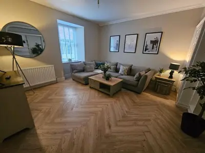 a living room with a couch and a table at HollyJess Hoose in Stranraer