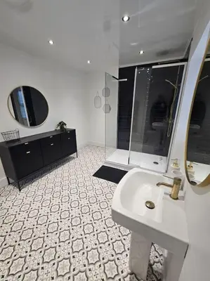 a white bathroom with a sink and a mirror at HollyJess Hoose in Stranraer