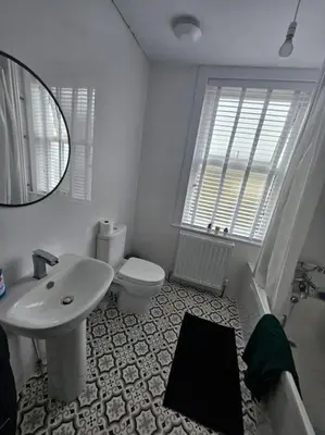a bathroom with a sink and a toilet and a mirror at HollyJess Hoose in Stranraer