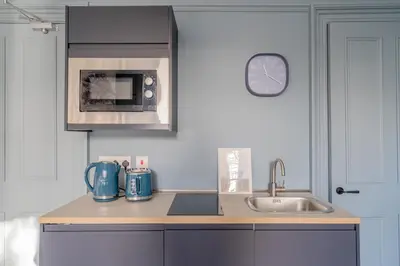 a kitchen with a sink and a microwave at Bluebell Studio Glasgow Airport in Paisley