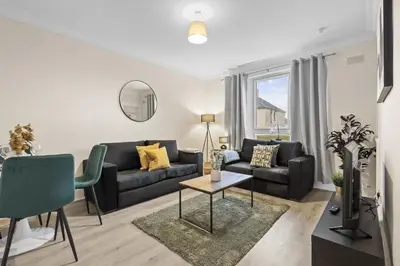a living room with a couch and a table at Welcoming Home in Johnstone, Near Glasgow Airport - Bonnie Lodgings in Johnstone