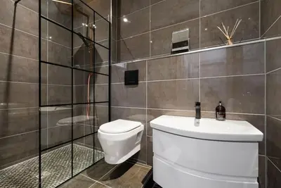 a bathroom with a toilet and a sink at Spacious modern city centre apartment Castle Views in Edinburgh
