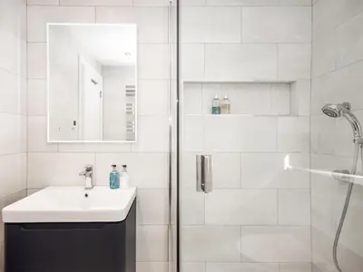 a white bathroom with a sink and a shower at The White House in Callander