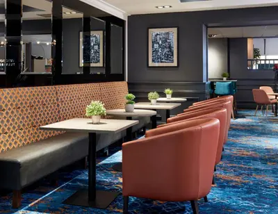 a row of tables and chairs in a restaurant at Leonardo Edinburgh Murrayfield in Edinburgh