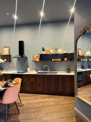a kitchen with a sink and a counter with a table at The Bank - Rooms & Apartments by Coorie Doon Stays in Troon