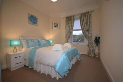 a bedroom with a bed and a window at Wallace Apartment in Stirling