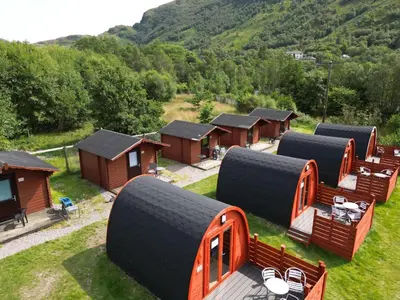 an aerial view of a group of huts with large tires at MacDonald Hotel & Cabins in Kinlochleven