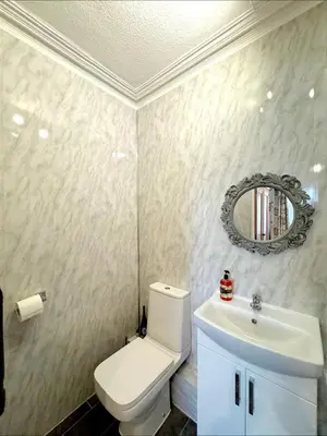 a bathroom with a white toilet and a sink at Ameliafield Cottage, Prestwick in Prestwick