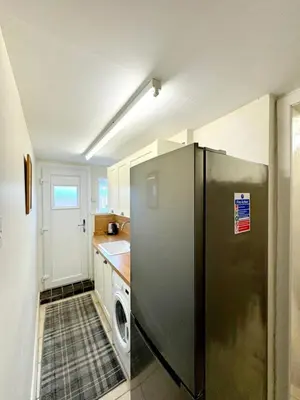 a kitchen with a stainless steel refrigerator and a dishwasher at Ameliafield Cottage, Prestwick in Prestwick