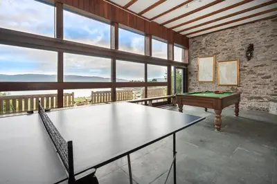 a ping pong table in a room with a pool table at Loch View House in Kilfinan