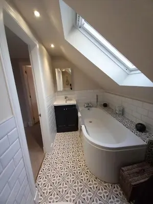 a bathroom with a large tub and a sink at Beautiful Historic Cottage in Callander