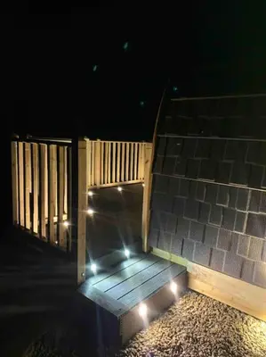 a wooden ramp with lights on it at night at The Pod Over By in Kilmichael Glassary