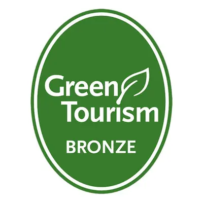 a green tourism promise sign in a green circle at Royal Scots Club in Edinburgh