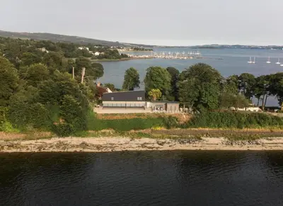 an aerial view of a house on an island in the water at Ferrypoint House in Rhu