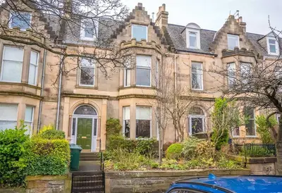 an old house with a car parked in front of it at Beautiful & bright 2 bed flat Murrayfield in Edinburgh