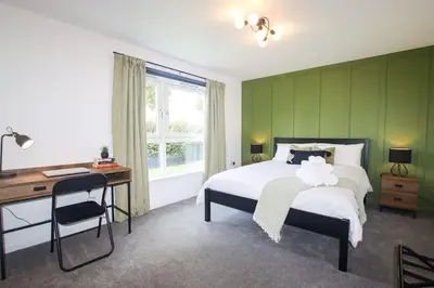 a bedroom with a bed and a desk and a window at City Hub by the Castle Free Designated Parking in Stirling