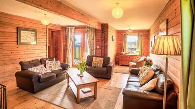 a living room with couches and a table at The New Farmhouse in Biggar