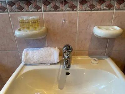 a sink with a faucet in a bathroom at 1930s 3Bed House in Quiet Village w/ Large Garden in Bishopton