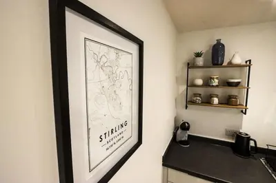 a picture hanging on a wall in a kitchen at City Views by the Castle, Free Designated Parking. in Stirling