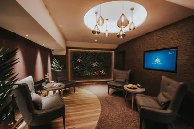 a waiting room with chairs and a large painting on the wall at Bowfield Hotel and Spa in Howwood