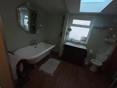 a bathroom with a tub and a toilet and a window at Lovely double room in very good area in Edinburgh