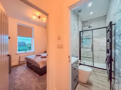 a bathroom with a bed and a shower and a toilet at Barassie, Troon in Troon
