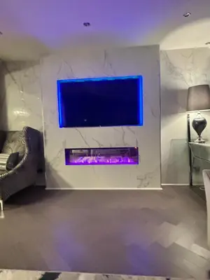 a living room with a tv on a wall at Large Modern Family Home in Murrayfield - Very close to City Centre - 10 mins by Direct Bus - Private Driveway & Garden in Edinburgh