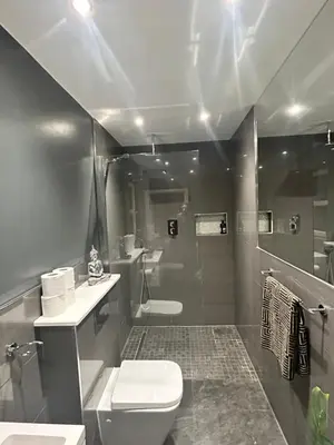 a bathroom with a toilet and a sink and a shower at Large Modern Family Home in Murrayfield - Very close to City Centre - 10 mins by Direct Bus - Private Driveway & Garden in Edinburgh