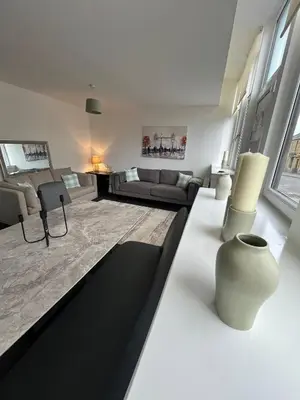 a living room with a couch and a table at The M Rooms at 144 in Kirk of Shotts