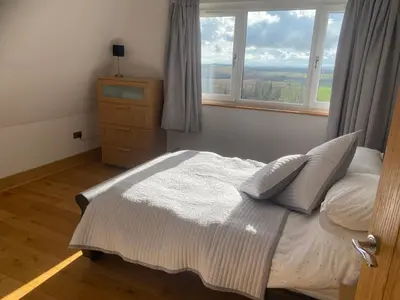 a bedroom with a bed and a window at The Annex at Meeks Park immaculate 2 bed in Alloa