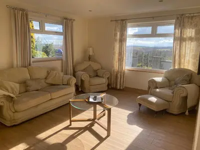 a living room with a couch and chairs and a table at The Annex at Meeks Park immaculate 2 bed in Alloa