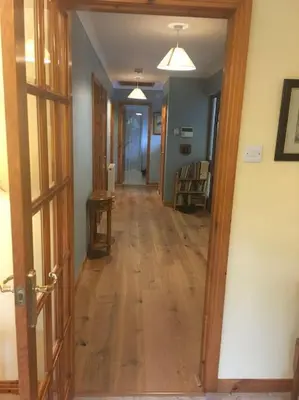 a hallway with an open door to a room at Fuaim Na Mara, The Sound Of The Sea. in Fort William