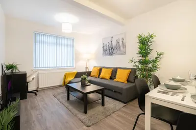 a living room with a couch and a table at 2 Bedroom Apartment-Free Parking-by Holiday Homes in Wishaw