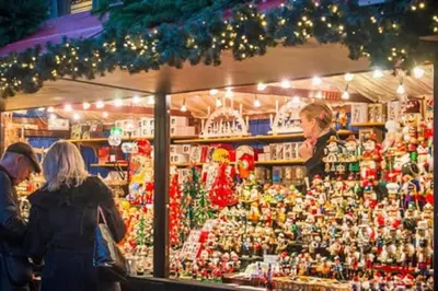 a group of people standing in front of a christmas market at Beautiful Victorian Apartment close to the Botanical gardens, Free parking! in Edinburgh
