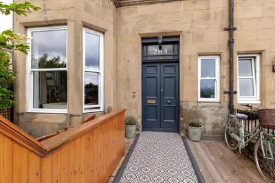 a front door of a house with a blue door at Beautiful Victorian Apartment close to the Botanical gardens, Free parking! in Edinburgh
