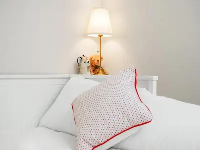 a bed with two stuffed animals and a lamp on it at Spacious Murrayfield Flat - Pass the Keys in Edinburgh